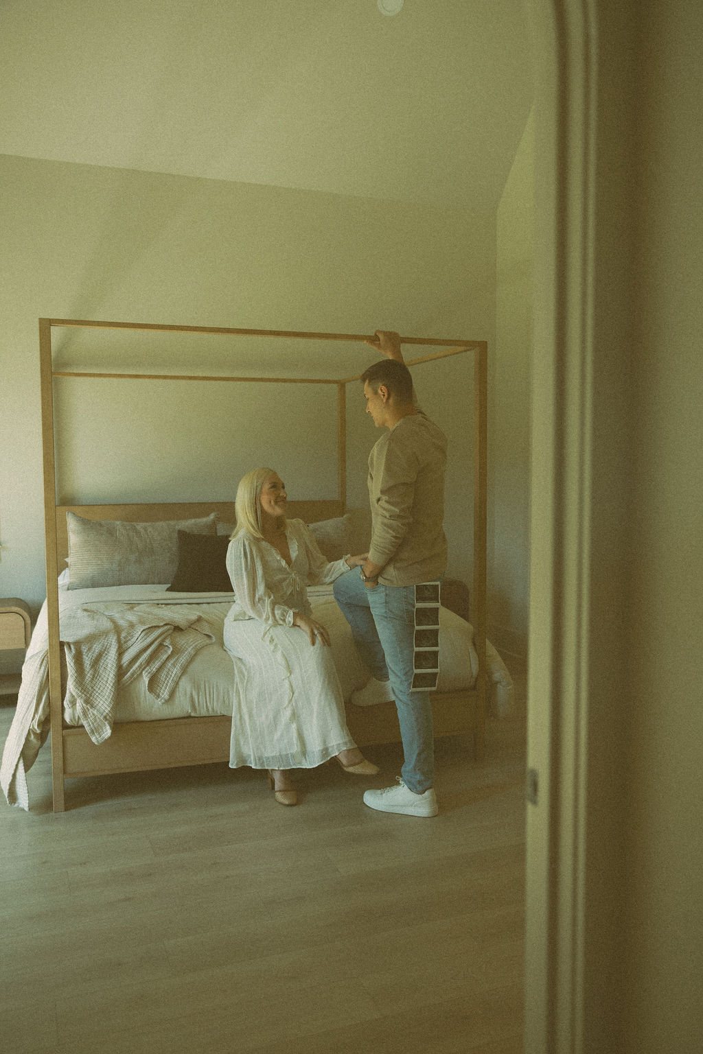 The primary suite: a canopy bed in soft window light